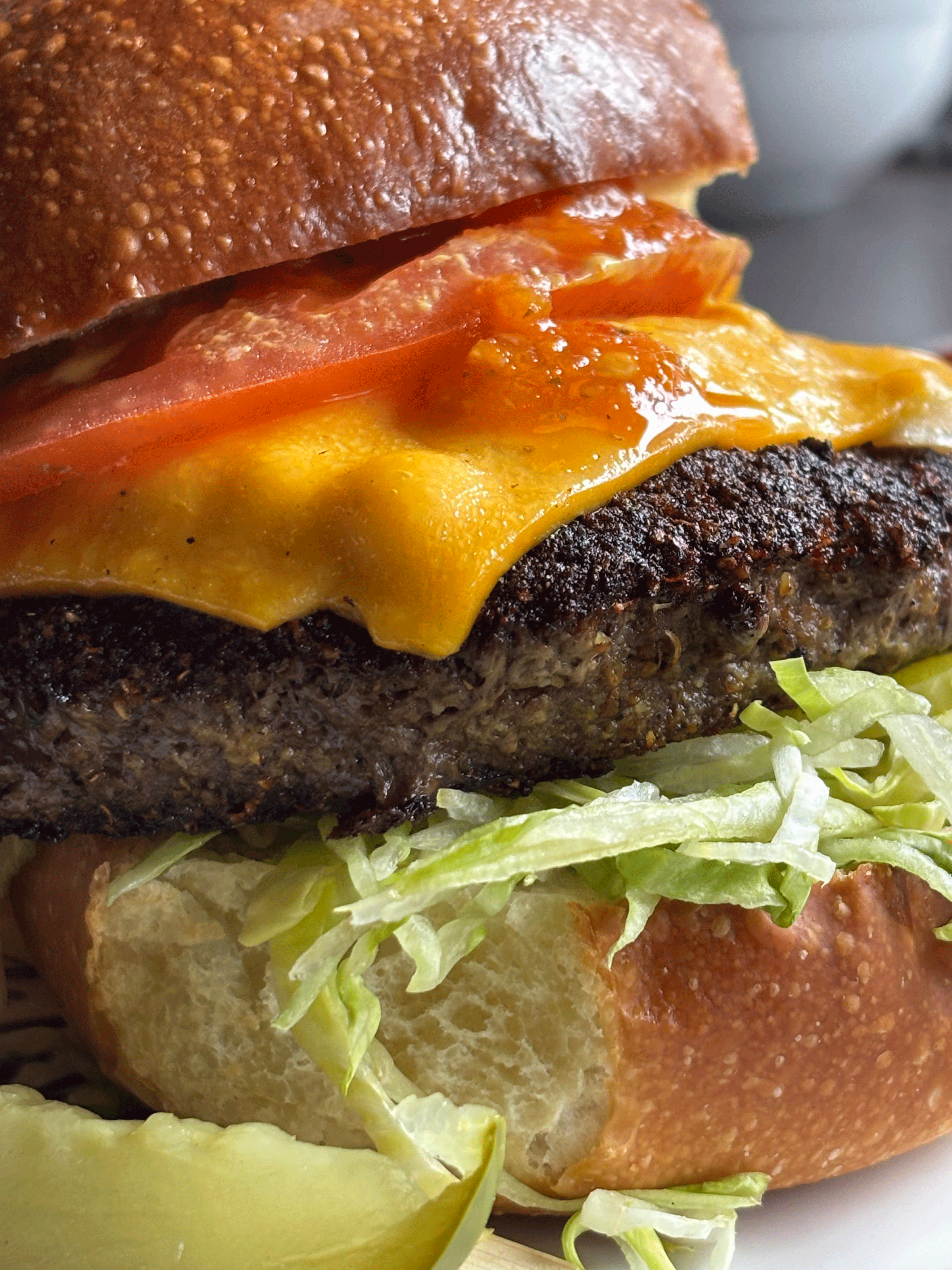 Pepper Dem hot sauce drizzled over a burger